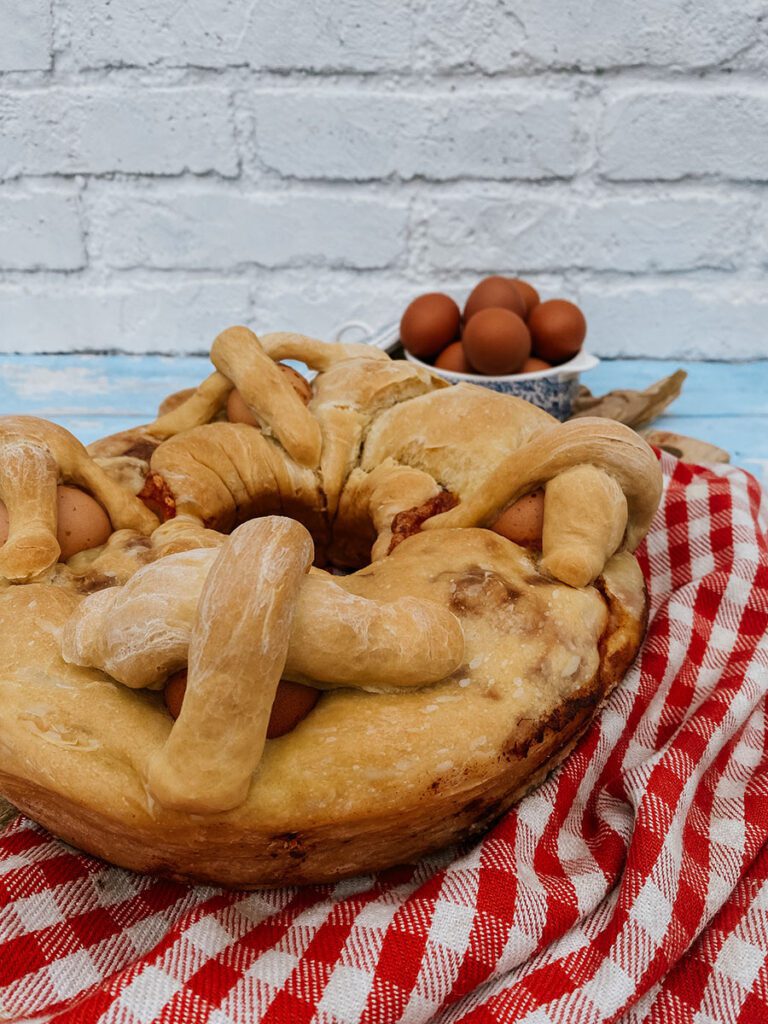 close up of casatiello bread recipe on a wooden board on a wooden background, eggs