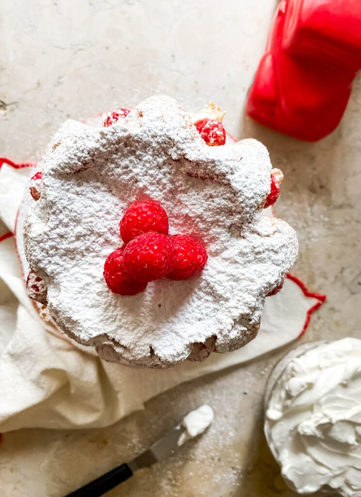 pandoro farcito from above with icing sugar and raspberries