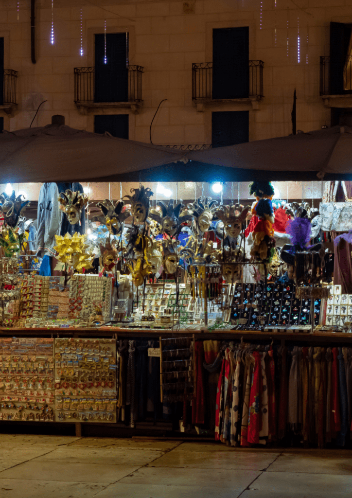 booths in the venice christmas market filled with masks and glass ornaments