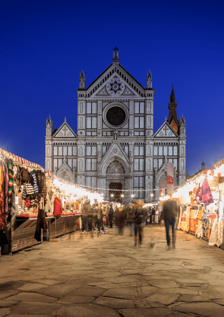 santa croce cathedral christmas market filled with booths with clothes and ornaments