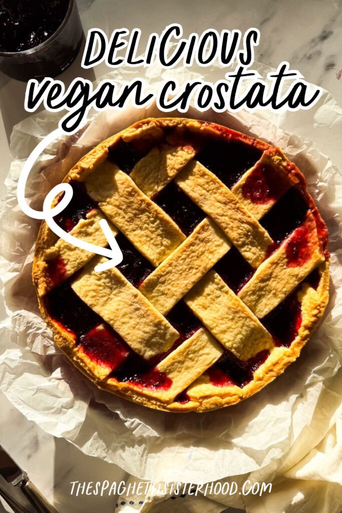 crostata on a marble background, jam on the side and cutlery