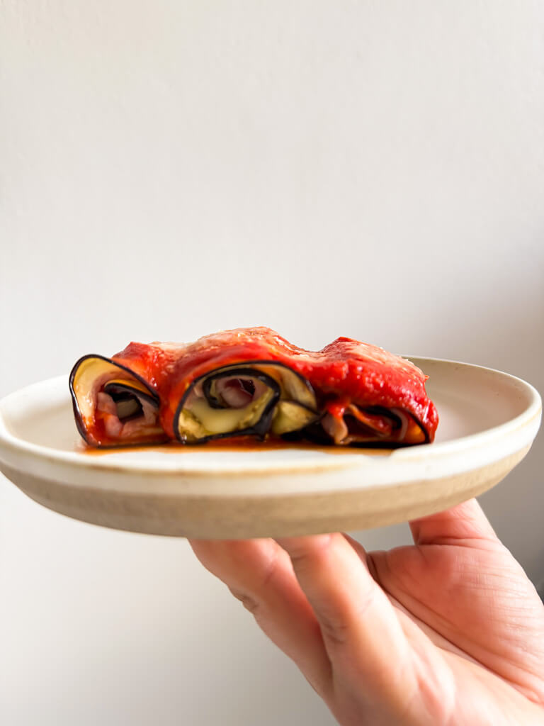 front detail of egglpant rollups on a plate